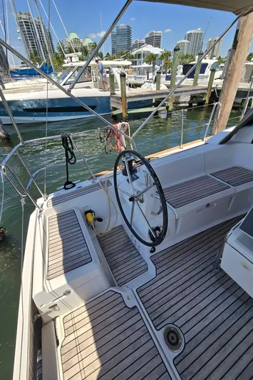  Yacht Photos Pics 2017 Jeanneau Sun Odyssey 389 sailboat cockpit with wheel, docked in marina.