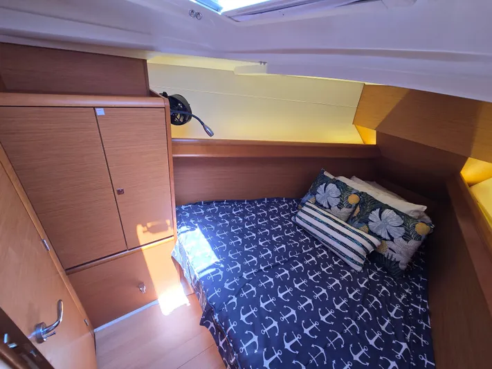  Yacht Photos Pics Cozy cabin interior of 2017 Jeanneau Sun Odyssey 389 with nautical-themed bedding.