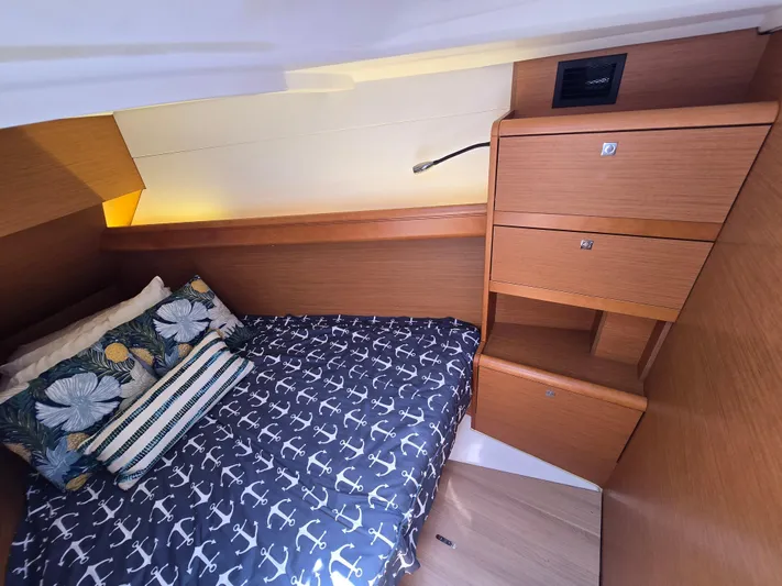  Yacht Photos Pics Cozy cabin interior of 2017 Jeanneau Sun Odyssey 389 with nautical-themed bedding.