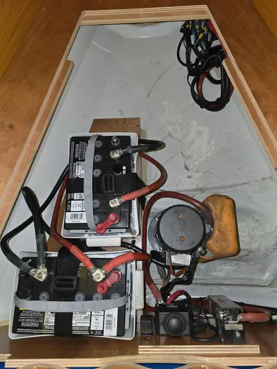  Yacht Photos Pics Battery compartment of a 2017 Jeanneau Sun Odyssey 389 sailboat, showing wiring and connections.