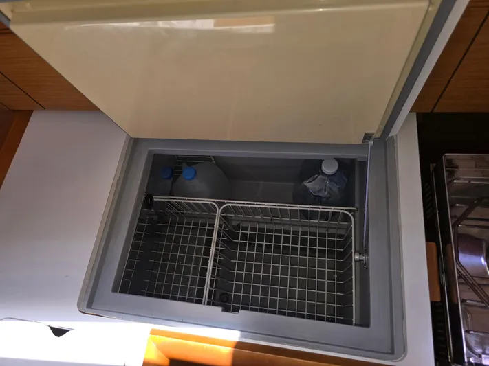  Yacht Photos Pics Open fridge compartment on 2017 Jeanneau Sun Odyssey 389 yacht, showing interior storage space.
