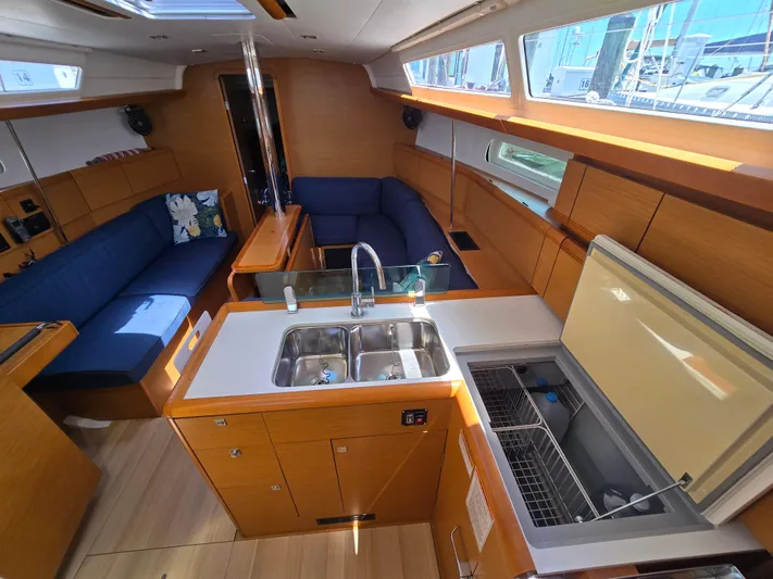  Yacht Photos Pics Interior of 2017 Jeanneau Sun Odyssey 389 sailboat with modern kitchen and seating area.