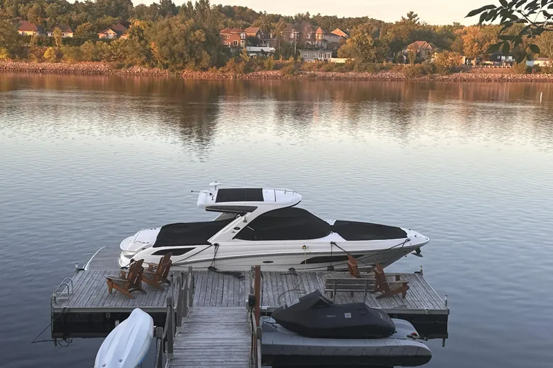  Yacht Photos Pics 2016 Sea Ray SLX 350 docked on a serene lake with scenic background.