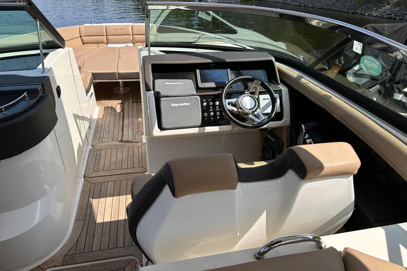  Yacht Photos Pics 2016 Sea Ray SLX 350 boat interior with steering wheel and seating, docked by the water.