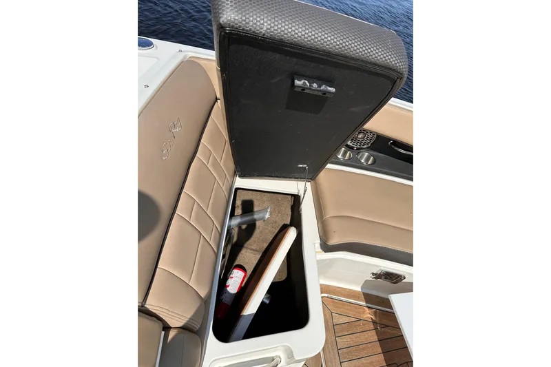  Yacht Photos Pics 2016 Sea Ray SLX 350 boat storage compartment with fire extinguisher and paddle.
