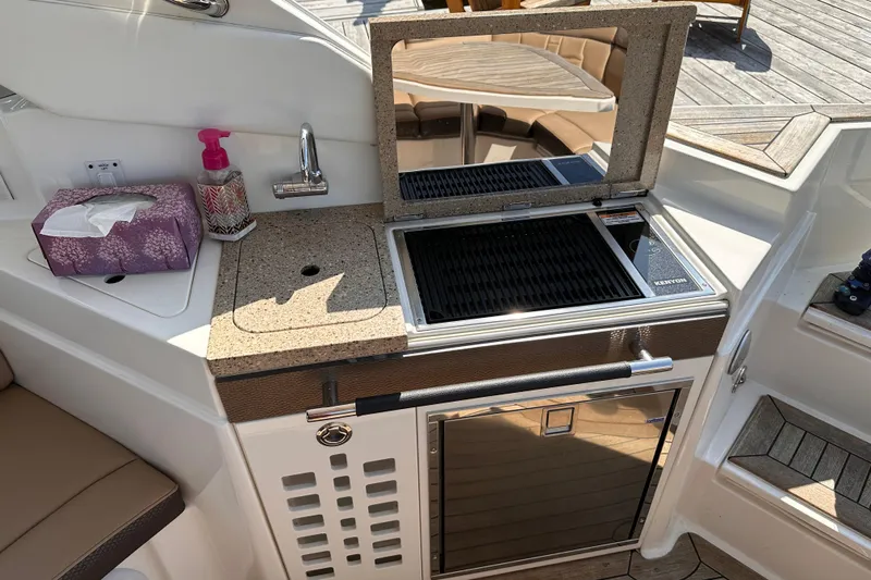  Yacht Photos Pics 2016 Sea Ray SLX 350 boat kitchenette with grill, sink, and countertop.