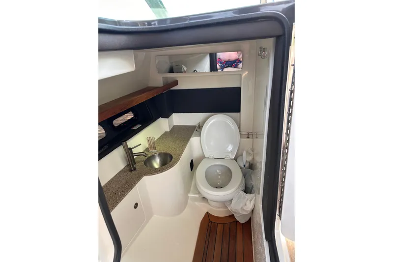 Yacht Photos Pics Interior of 2016 Sea Ray SLX 350 boat bathroom with sink and toilet.