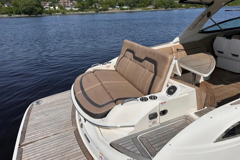  Yacht Photos Pics 2016 Sea Ray SLX 350 boat with luxurious seating and wooden deck by the water.