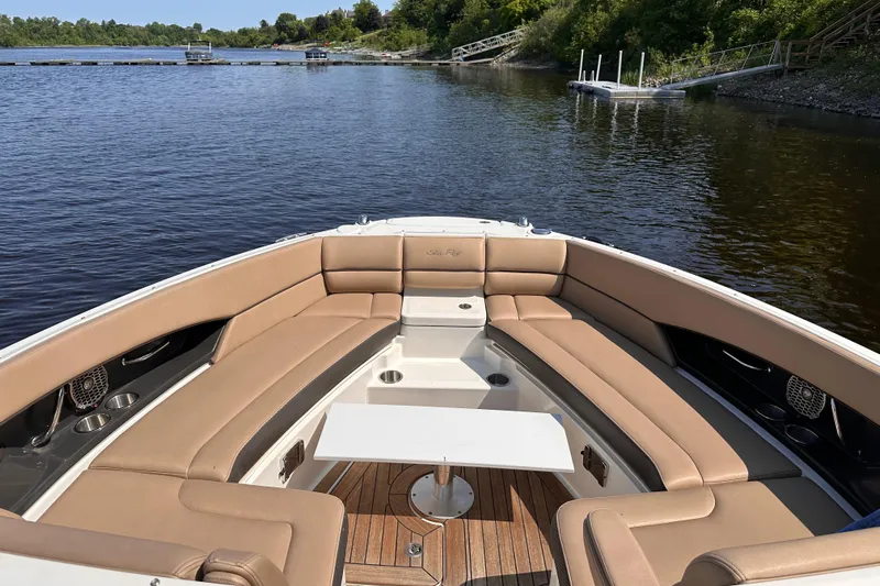  Yacht Photos Pics 2016 Sea Ray SLX 350 boat interior with tan seating and table on a calm lake.