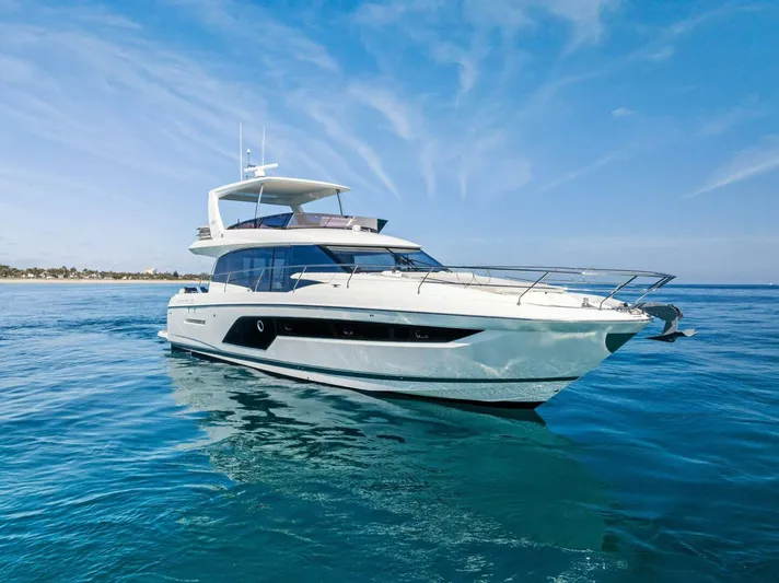 Anna Louise Yacht Photos Pics 2022 Prestige 590 Flybridge yacht on calm blue waters under a clear sky.