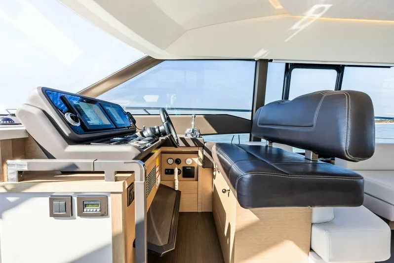 Anna Louise Yacht Photos Pics 2022 Prestige 590 Flybridge yacht interior with modern helm and leather seating.