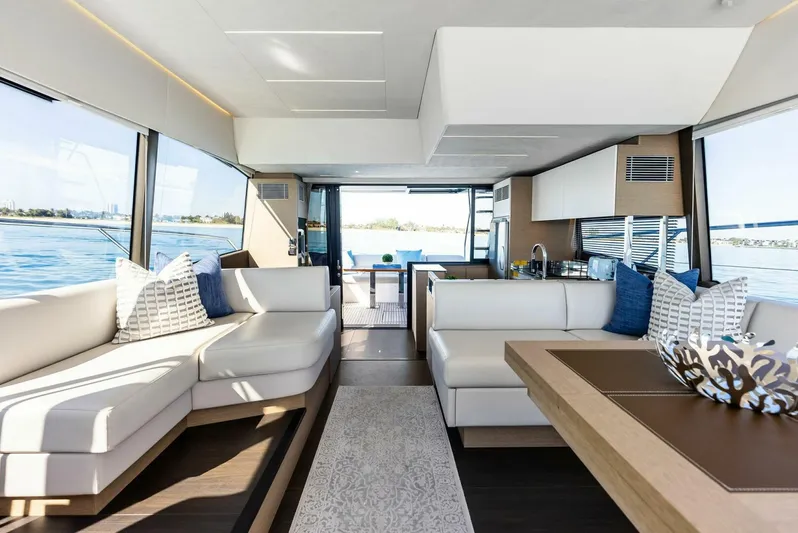 Anna Louise Yacht Photos Pics Luxurious interior of 2022 Prestige 590 flybridge yacht with modern furnishings and panoramic windows.