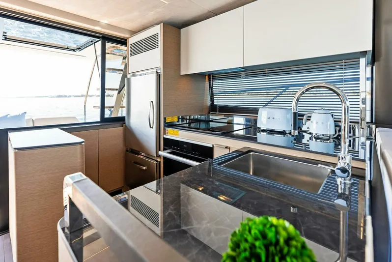 Anna Louise Yacht Photos Pics Modern kitchen interior on 2022 Prestige 590 flybridge yacht, featuring sleek appliances and stylish design.