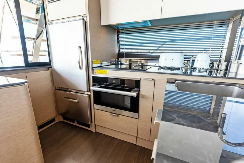 Anna Louise Yacht Photos Pics Modern kitchen in 2022 Prestige 590 Flybridge yacht with stainless steel appliances and sleek cabinetry.