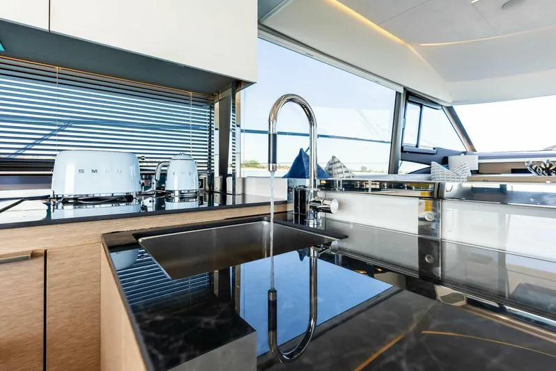 Anna Louise Yacht Photos Pics Modern kitchen interior on 2022 Prestige 590 flybridge yacht, featuring sleek countertops and appliances.