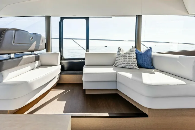 Anna Louise Yacht Photos Pics Interior of 2022 Prestige 590 Flybridge yacht with modern white seating and cushions.