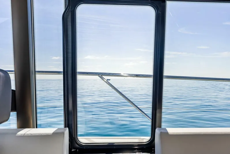 Anna Louise Yacht Photos Pics View from 2022 Prestige 590 Flybridge yacht window overlooking calm sea.