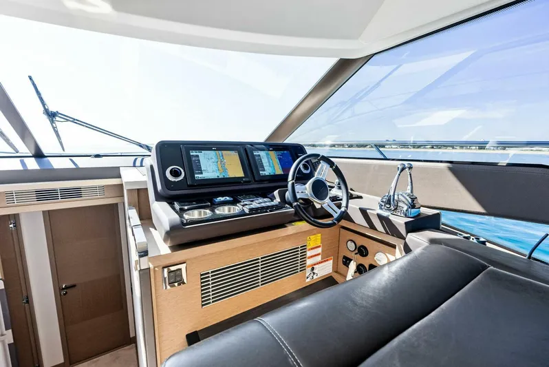 Anna Louise Yacht Photos Pics 2022 Prestige 590 Flybridge yacht helm with modern navigation displays and luxurious leather seating.