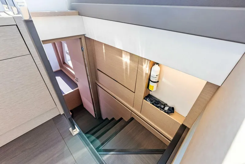 Anna Louise Yacht Photos Pics Interior stairs of 2022 Prestige 590 Flybridge yacht, featuring modern design and wood finish.