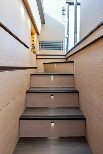 Anna Louise Yacht Photos Pics Staircase on 2022 Prestige 590 Flybridge yacht, featuring modern design and ambient lighting.