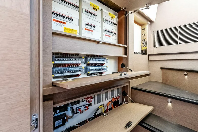 Anna Louise Yacht Photos Pics Electrical panel inside 2022 Prestige 590 Flybridge yacht, showcasing circuit breakers and wiring.