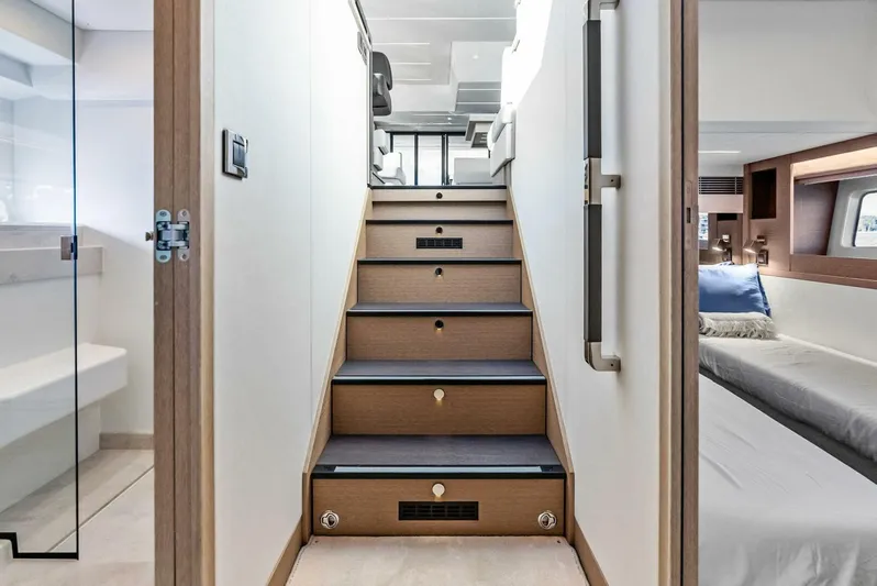 Anna Louise Yacht Photos Pics Interior stairs of 2022 Prestige 590 flybridge yacht, leading to upper deck.