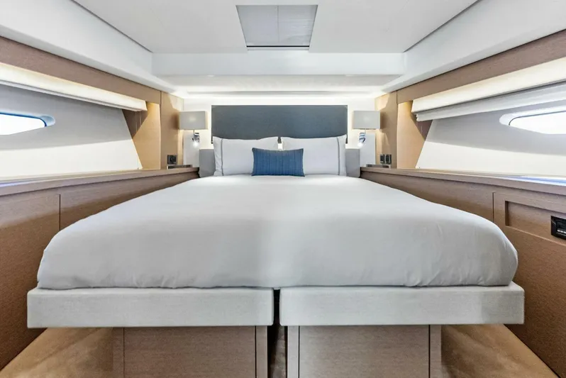 Anna Louise Yacht Photos Pics Luxurious bedroom interior of 2022 Prestige 590 Flybridge yacht, featuring elegant bedding and modern design.