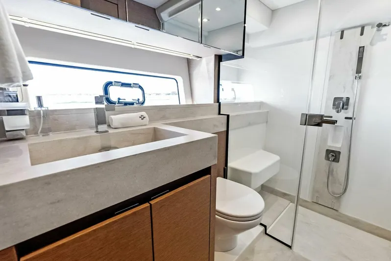Anna Louise Yacht Photos Pics Modern bathroom in 2022 Prestige 590 Flybridge yacht with sleek fixtures and glass shower.