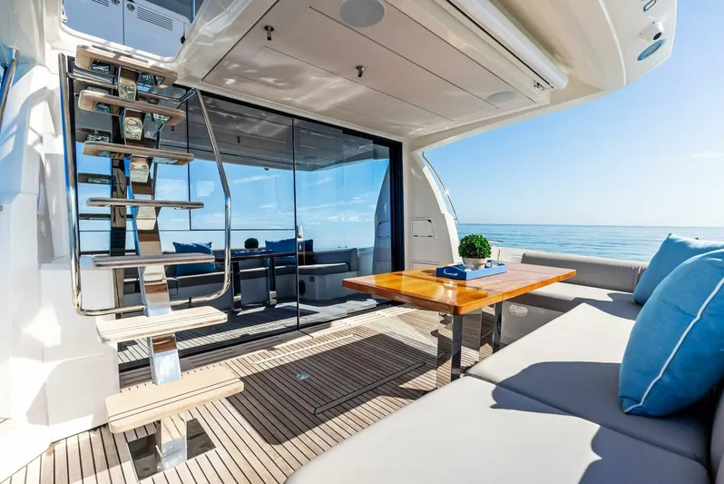 Anna Louise Yacht Photos Pics Prestige 590 Flybridge 2022 yacht interior with seating, table, and ocean view.