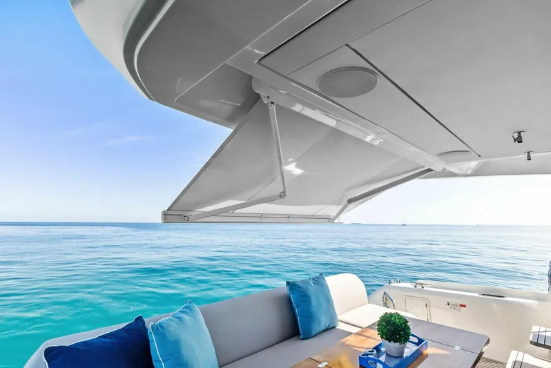 Anna Louise Yacht Photos Pics 2022 Prestige 590 Flybridge yacht with luxurious seating, ocean view, and elegant design.