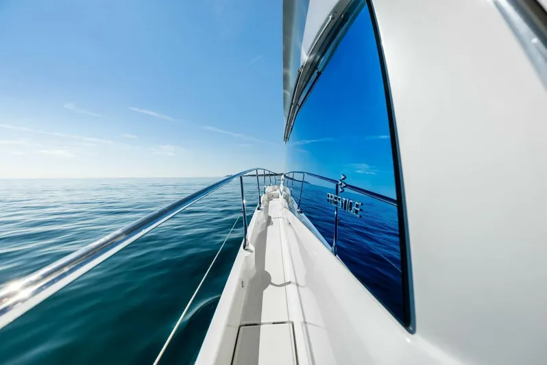 Anna Louise Yacht Photos Pics Prestige 590 Flybridge yacht, 2022 model, cruising on calm ocean waters.