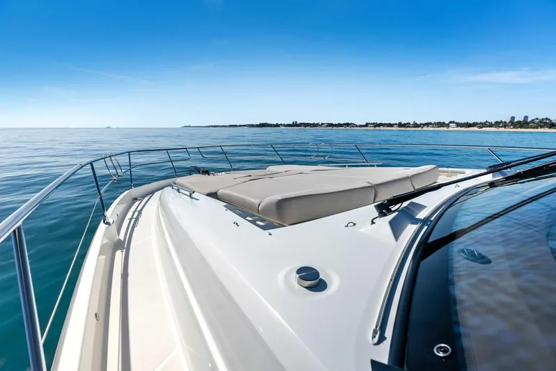 Anna Louise Yacht Photos Pics Prestige 590 Flybridge 2022 yacht on calm sea, featuring spacious deck and sunbathing area.