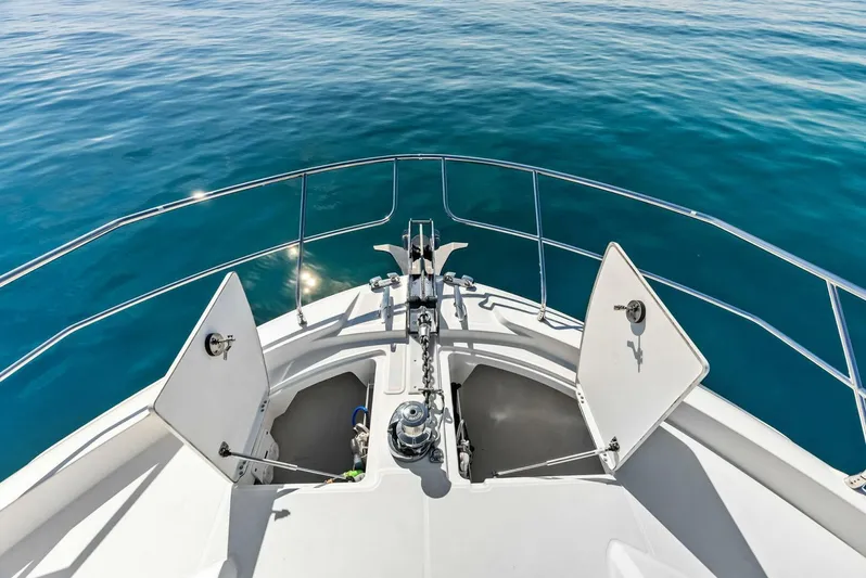 Anna Louise Yacht Photos Pics Prestige 590 Flybridge 2022 yacht bow with open anchor compartments on calm sea.