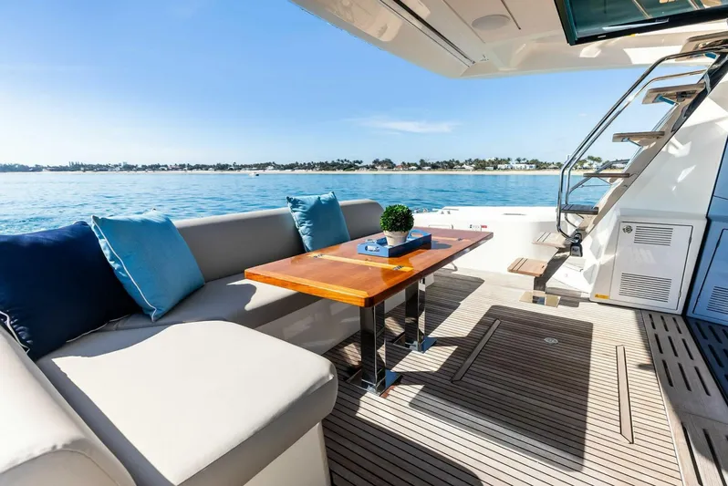 Anna Louise Yacht Photos Pics Prestige 590 flybridge yacht 2022, featuring elegant outdoor seating and ocean view.