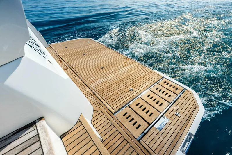 Anna Louise Yacht Photos Pics Prestige 590 Flybridge 2022 yacht deck with teak flooring on calm water.