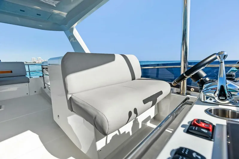 Anna Louise Yacht Photos Pics 2022 Prestige 590 Flybridge yacht interior with helm and seating, ocean view.