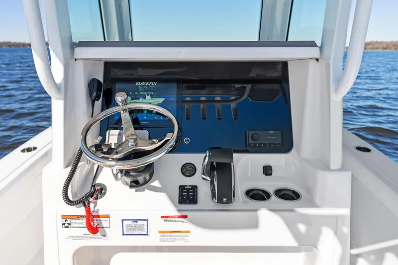 Your Next Boat! Yacht Photos Pics Manufacturer Provided Image: 2026 Blackfin 262 HB boat dashboard with steering wheel and controls on open water.
