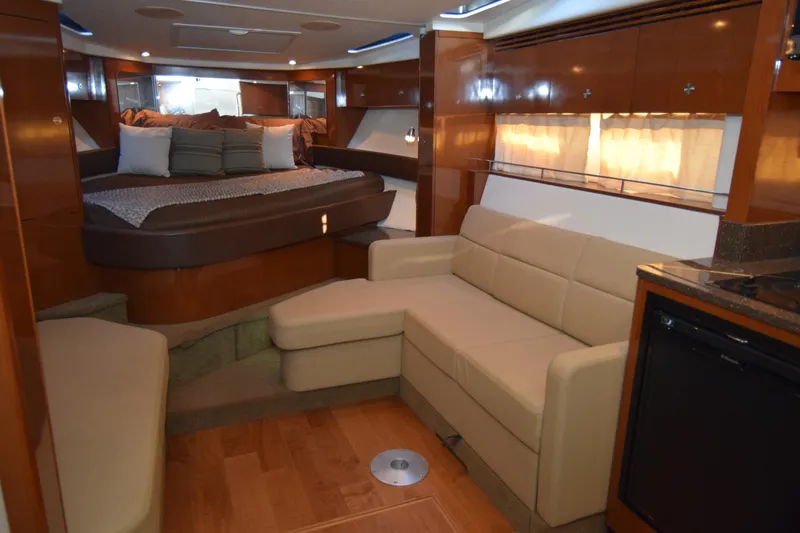 Just Plane Fun Yacht Photos Pics Luxurious interior of 2014 Sea Ray 350 Sundancer yacht with cozy seating and elegant wood finishes.