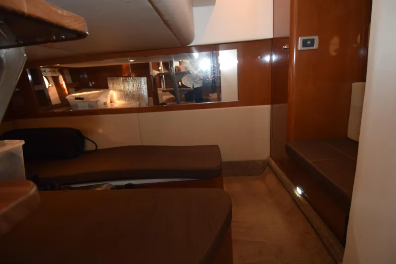 Just Plane Fun Yacht Photos Pics Interior cabin of 2014 Sea Ray 350 Sundancer with brown seating and wood paneling.
