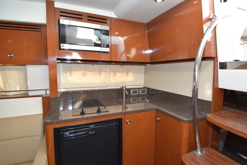 Just Plane Fun Yacht Photos Pics Interior of 2014 Sea Ray 350 Sundancer yacht kitchen with modern appliances.