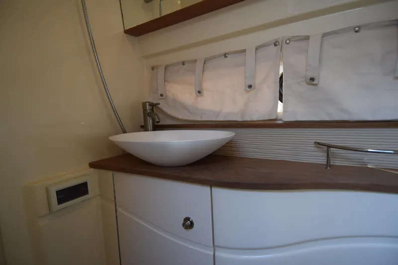 Just Plane Fun Yacht Photos Pics 2014 Sea Ray 350 Sundancer bathroom with modern sink and wooden countertop.