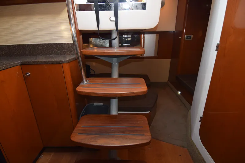Just Plane Fun Yacht Photos Pics Interior stairs of 2014 Sea Ray 350 Sundancer yacht, featuring wooden steps and modern design.