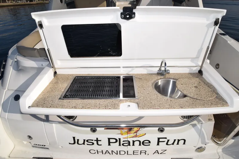 Just Plane Fun Yacht Photos Pics Outdoor kitchenette on 2014 Sea Ray 350 Sundancer boat, featuring grill and sink.