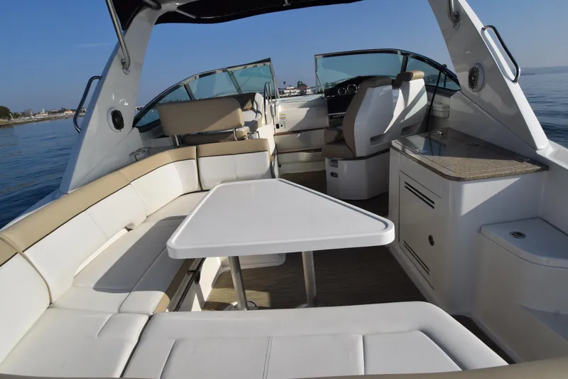 Just Plane Fun Yacht Photos Pics 2014 Sea Ray 350 Sundancer interior with seating and table, open water view.