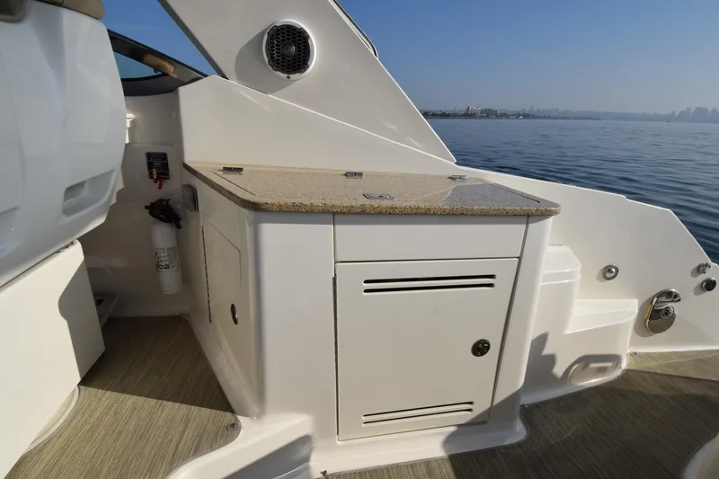 Just Plane Fun Yacht Photos Pics 2014 Sea Ray 350 Sundancer boat interior with sleek cabinetry with refrigerator