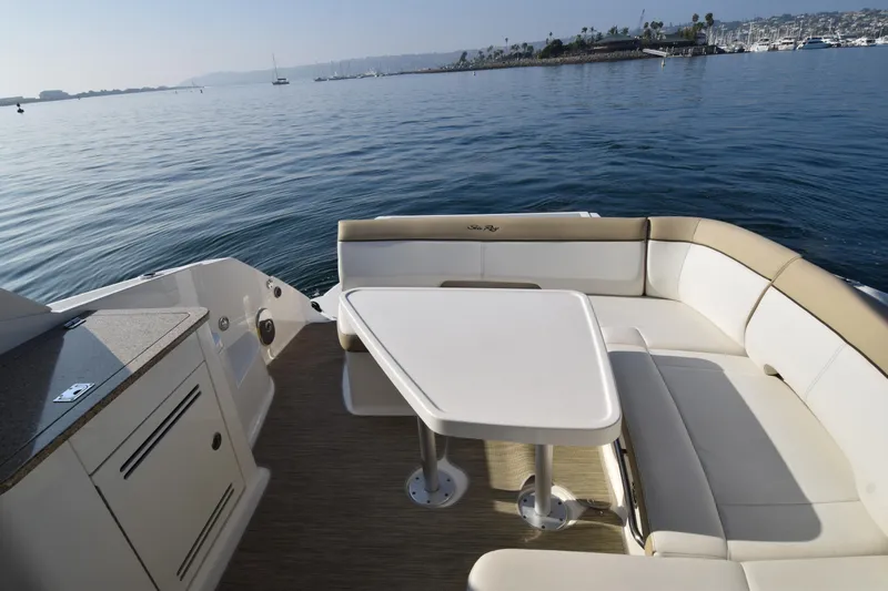 Just Plane Fun Yacht Photos Pics 2014 Sea Ray 350 Sundancer boat interior with seating and table on calm water.