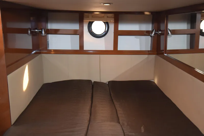 Just Plane Fun Yacht Photos Pics Cozy cabin interior of 2014 Sea Ray 350 Sundancer with twin beds and porthole window.