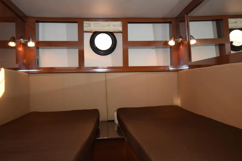 Just Plane Fun Yacht Photos Pics Interior cabin of 2014 Sea Ray 350 Sundancer with twin beds and porthole window.