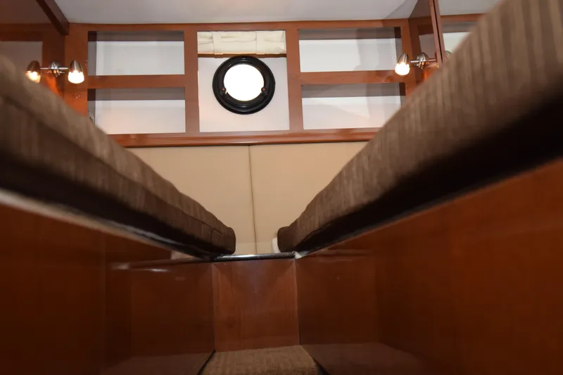 Just Plane Fun Yacht Photos Pics Interior cabin view of 2014 Sea Ray 350 Sundancer yacht, featuring wood paneling and porthole.