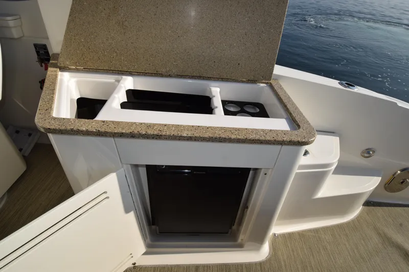 Just Plane Fun Yacht Photos Pics 2014 Sea Ray 350 Sundancer boat kitchenette with countertop and mini fridge.